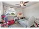 A bedroom is bright and airy with a ceiling fan and a sunny window at 19917 Mitchell Cir, Denver, CO 80249