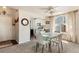Open dining area with modern table, light-filled arched window, and seamless flow to the kitchen at 19917 Mitchell Cir, Denver, CO 80249