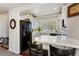 Well-lit kitchen with a breakfast bar area, sleek appliances, and a view through the arch to the dining area at 19917 Mitchell Cir, Denver, CO 80249
