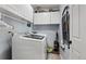 Bright laundry room features a modern washer and dryer set and ample storage cabinets at 19917 Mitchell Cir, Denver, CO 80249