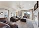 Spacious living area with a fireplace, plush seating, and ample natural light from the sliding glass door at 19917 Mitchell Cir, Denver, CO 80249