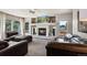 Comfortable living room features a fireplace, a large window, and neutral colors that creates a cozy atmosphere at 19917 Mitchell Cir, Denver, CO 80249