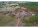 Extensive aerial view of a two-story home and guest house surrounded by rolling hills and mature trees at 2100 Bibles Hill Dr, Franktown, CO 80116