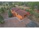 Aerial view of a two-story home with an attached drive-through garage and a large front yard at 2100 Bibles Hill Dr, Franktown, CO 80116