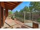 Fenced backyard with mature trees, a brick patio, and a peaceful, private setting at 2100 Bibles Hill Dr, Franktown, CO 80116
