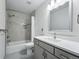 Updated bathroom featuring shower-tub combo, and a grey vanity at 2100 Bibles Hill Dr, Franktown, CO 80116