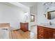 Bright bathroom with double sink vanity and soaking tub featuring neutral toned tile and ample counter space at 2100 Bibles Hill Dr, Franktown, CO 80116