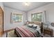 Cozy bedroom featuring two large windows and rustic decor at 2100 Bibles Hill Dr, Franktown, CO 80116