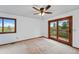 Spacious bedroom with natural light, access to private deck, and ceiling fan, offers relaxation at 2100 Bibles Hill Dr, Franktown, CO 80116