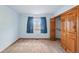 Bedroom with blue walls, closet, neutral carpet and window with an outdoor view at 2100 Bibles Hill Dr, Franktown, CO 80116