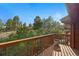 Deck view showcases natural landscape with lush trees and a private tranquil setting at 2100 Bibles Hill Dr, Franktown, CO 80116