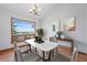 Dining room featuring a marble table, seating for six, a large window, and modern artwork at 2100 Bibles Hill Dr, Franktown, CO 80116
