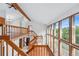 Foyer with wooden railings, vaulted ceilings, and large windows at 2100 Bibles Hill Dr, Franktown, CO 80116