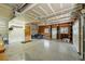 Spacious garage with epoxy flooring, ample storage, and space for multiple vehicles at 2100 Bibles Hill Dr, Franktown, CO 80116