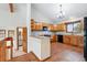 Traditional kitchen with honey-toned cabinets, granite countertops, and black appliances offering ample storage and prep space at 2100 Bibles Hill Dr, Franktown, CO 80116