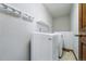 Laundry room featuring side-by-side washer and dryer and coat hooks above at 2100 Bibles Hill Dr, Franktown, CO 80116