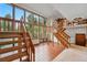 Spacious living room with grand staircase and a wall of windows at 2100 Bibles Hill Dr, Franktown, CO 80116