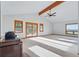 Spacious living room with fireplace and sliding doors to deck at 2100 Bibles Hill Dr, Franktown, CO 80116