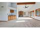 Open concept living room with fireplace, bar and sliding doors at 2100 Bibles Hill Dr, Franktown, CO 80116