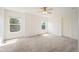 Bright bedroom showcasing two large windows, neutral carpet, and a ceiling fan at 5875 Raleigh Cir, Castle Rock, CO 80104