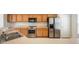 Functional kitchen with stainless steel appliances and oak cabinets at 5875 Raleigh Cir, Castle Rock, CO 80104
