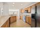 Kitchen with stainless steel appliances and adjacent living room at 5875 Raleigh Cir, Castle Rock, CO 80104