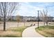 Peaceful walking path leading towards homes, enhanced with trees and benches at 5875 Raleigh Cir, Castle Rock, CO 80104