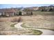 Scenic view of a winding path through an open field, surrounded by homes at 5875 Raleigh Cir, Castle Rock, CO 80104