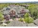 A high aerial shot showing the red roof and tree-lined surroundings of the townhouse complex at 843 Snowberry St, Longmont, CO 80503