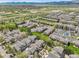 An aerial view of townhouses in a community, with a baseball field and park visible in the background at 843 Snowberry St, Longmont, CO 80503