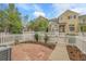 Private backyard featuring a stone patio, white picket fence, and well-manicured lawn, perfect for outdoor entertaining at 843 Snowberry St, Longmont, CO 80503