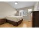 Bright bedroom featuring wood floors, vaulted ceiling, and a ceiling fan at 843 Snowberry St, Longmont, CO 80503