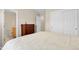 A bright bedroom with a peek into the bathroom and closet, featuring neutral colors at 843 Snowberry St, Longmont, CO 80503