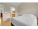 Cozy bedroom features wood floors and an open archway to the bathroom at 843 Snowberry St, Longmont, CO 80503