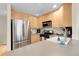 Modern kitchen with stainless steel appliances, light wood cabinetry, and a functional layout, ideal for cooking and entertaining at 843 Snowberry St, Longmont, CO 80503