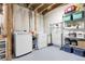 Well-equipped laundry room features a modern washer, dryer and ample shelving for organized storage at 843 Snowberry St, Longmont, CO 80503