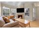 Cozy living room with a fireplace, comfortable seating, and large windows, ideal for relaxing and entertaining guests at 843 Snowberry St, Longmont, CO 80503
