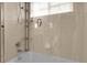This bathroom shower features shelving, chrome hardware, and a shower curtain at 843 Snowberry St, Longmont, CO 80503