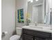 Powder room features a modern vanity with marble countertop, toilet and modern finishes at 5290 Silver Hare Ct, Castle Rock, CO 80104