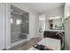 Modern bathroom features tiled shower with glass door, soaking tub, and double sink vanity at 5290 Silver Hare Ct, Castle Rock, CO 80104