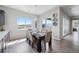 Bright dining area with a modern chandelier, sliding door, and scenic outdoor views at 5290 Silver Hare Ct, Castle Rock, CO 80104