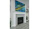 Close-up of a modern fireplace with gray stone and decorative mantel at 5290 Silver Hare Ct, Castle Rock, CO 80104