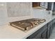 Close-up of kitchen with modern countertops and a stainless steel cooktop at 5290 Silver Hare Ct, Castle Rock, CO 80104
