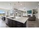 Open kitchen with a center island, stylish sink, connecting dining area, and living room at 5290 Silver Hare Ct, Castle Rock, CO 80104