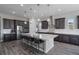 Spacious kitchen featuring a large island, modern stainless steel appliances, and sleek pendant lighting at 5290 Silver Hare Ct, Castle Rock, CO 80104