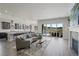Open-concept living space with a fireplace, kitchen, and scenic deck access at 5290 Silver Hare Ct, Castle Rock, CO 80104