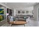 Open-concept living space with a stylish couch, modern lighting, and seamless flow to the kitchen at 5290 Silver Hare Ct, Castle Rock, CO 80104