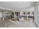 Spacious open-concept living room with modern kitchen and stylish gray wood flooring at 5290 Silver Hare Ct, Castle Rock, CO 80104