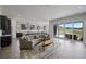 Open-concept living area with a stylish couch, modern lighting, kitchen, and access to the outdoor deck at 5290 Silver Hare Ct, Castle Rock, CO 80104