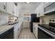 Well-lit kitchen featuring white cabinets, black appliances, and tiled floors at 4068 S Atchison Way # 301, Aurora, CO 80014